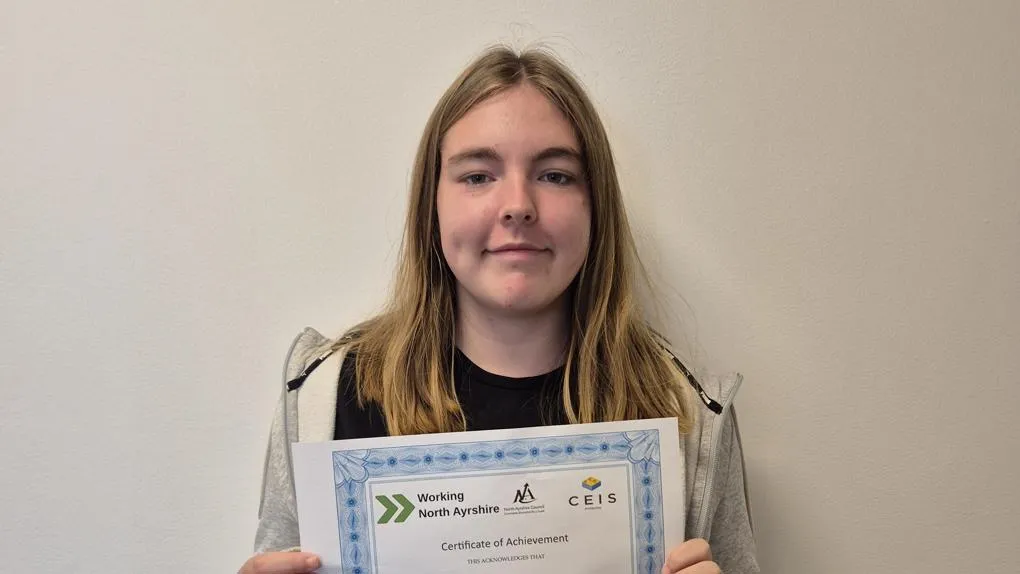 Participant holding certificate of achievement